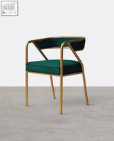 A sleek attleboro dining chair with gold metal frame and plush emerald green velvet upholstery perfect for dining