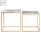 Two minimalist square marble side tables with gold nesting metal frames in the avantis set of 2
