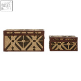 Two aztec storage trunks with woven geometric pattern in beige and dark brown tones made of galvanised iron