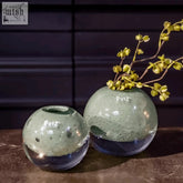 Two mouth blown glass ball vases from dutz collection in speckled sage green and deep blue pistache bubbles design