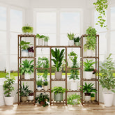Brown wooden bamworld plant stand with multiple shelves holding white and green pots for living room decor