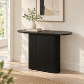 Black oval Barbican 110cm console table with close vertical fluting and ribbed texture for stylish storage