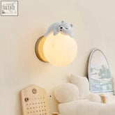 Cute white polar bear wall light with soft glowing spherical base perfect for kids nursery or bedroom decor