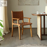 Beau brown dining chair with brown leather-wrapped ash wood frame and woven seat and back with armrest