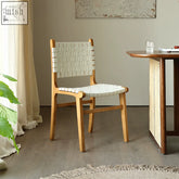 A minimalist dining chair with a woven white leather seat and backrest made of ash wood without armrest