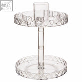 Clear crystal two tier revolving cosmetic organiser with faceted edges and central cylindrical opening for storage