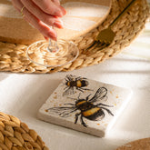 Bee single stone coaster with two detailed bees on natural limestone off-white heat resistant surface