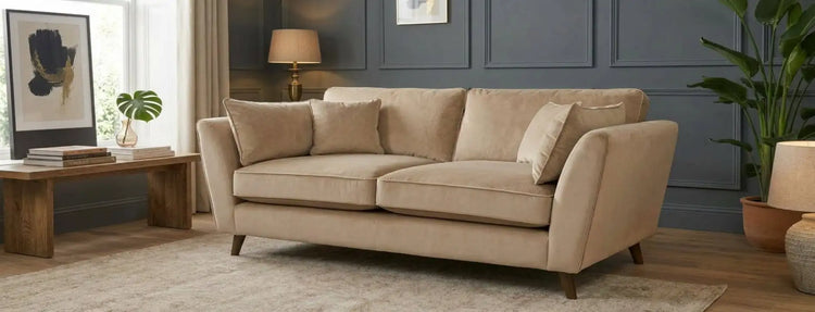 Beige upholstered sofa with rolled arms and wooden legs.