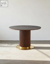 Bek round dining table with dark wood top and fluted wooden pedestal base with gold-toned metal rings brown dining table