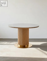 Bek round dining table with a sleek white marble top and golden fluted wooden base perfect as a round dining table