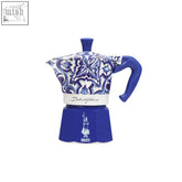 Blue and white ceramic Bialetti x Dolce&Gabbana mediterranean moka express with floral patterns and solid blue handle and lid