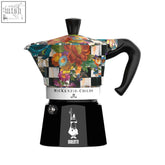 A vibrant floral and checkered bialetti x mackenzie childs moka express with black handle and base perfect for coffee fans