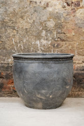 Big old grey asian pots featuring dark gray weathered ceramic with embossed circles and rope band around the rim