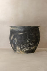 A rustic handcrafted ceramic grey asian pot with dark gray and white glaze and incised diagonal lines big old grey asian pots