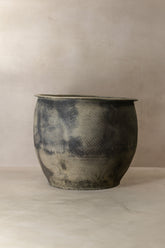 A rustic handcrafted ceramic big old grey asian pot with mottled gray and black glaze finish