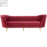 A plush wine velvet sofa with tufted back and sleek gold-tone legs perfect for stylish living spaces