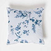 White cotton throw cushion with delicate blue roses cotton floral pattern featuring birds and vines design