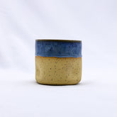 Blunero goccia handmade ceramic stoneware cup with speckled beige body and vibrant blue glazed rim