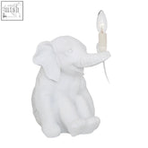 White ceramic boho elephant table lamp with candle style bulb held in trunk perfect elephant table lighting