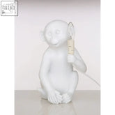 Boho white finish monkey lamp with white ceramic body clear glass bulb and beige base perfect for cozy decor