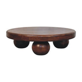 Round wooden bola coffee table trivet with smooth dark brown finish and three spherical feet for tabletop use