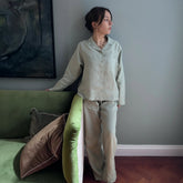 A soft light green bolney eucalyptus wide leg linen pyjama set with a button-up shirt and matching pants