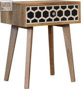 A modern tapered bedside table in solid mango wood with bone inlay geometric drawer pattern in black and white