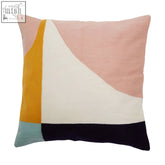 A bosie ozella abstract cushion with bold geometric panels in pink mustard white and navy blue textured fabric