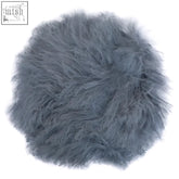 A plush bosie real mongolian fur grey round cushion with soft fluffy texture and slightly matted edges