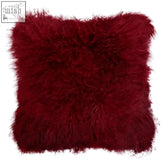 A plush deep red bosie real mongolian fur maroon square cushion with soft fluffy texture and slightly frayed edges