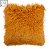 A bosie real mongolian lamb fur ochre square cushion with shaggy, fluffy, vibrant orange lamb fur texture