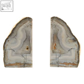 Natural stone bowerbird agata gold bookends with layered gray white and earthy brown hues showing natural depth