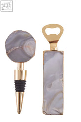 A bowerbird agata stopper set with sleek gold tone and polished gray agate slices featuring natural veining