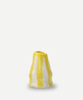 A small ceramic candle holder with bright yellow and white vertical candy stripes perfect for home decor