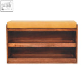 A mustard-yellow upholstered shoe storage bench with three shelves made of solid mango wood for organized shoe storage