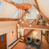 Rustic wooden spool chandelier with hanging filament bulbs ideal for stairwell lighting uk check current lead time for client area