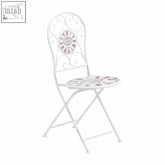 White wrought iron cafe cassis cream powder coated folding chair with ornate scrollwork back and mosaic seat