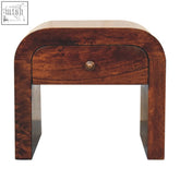 A sleek california walnut disc bedside table with smooth round edges dark brown finish and brass knob drawer