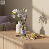 Clear glass camomile violet orris diffuser with black reeds and lavender label for vintage aromatherapy and deep tranquility