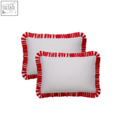 White rectangular candy cane pillow cases with vibrant red ruffled trim and high thread count fabric