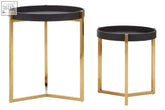 Two black faux shagreen tray tables with black circular tops and gold-tone metal frames minimalist side tables