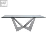Modern Carlox dining table with clear tempered glass top and sleek chrome v-shaped legs for stylish dining room use