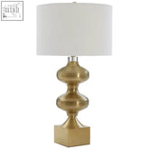 Carly brass table lamp with a gold-toned base featuring stacked textured glass globes and a white cylindrical shade