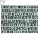The carnival glass chopping board is a rectangular glass chopping board with a dark gray text pattern on a light gray background
