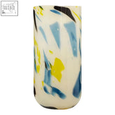 Tall cylindrical glass vase with creamy white base and abstract glass swirls of blue yellow and black carra large design
