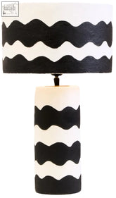 Carta black and white curved stripe papier mache table lamp with a cylindrical base and wavy curved stripe design