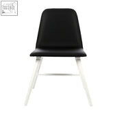 Black leather dining chair with sleek white legs featuring cassy black leather effect for modern dining spaces