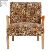 A mid-century modern cefena leopard print chair with tan and brown fabric and light wood arms and legs