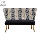 Black velvet cefena moroccan bench with cream and black textured geometric throw draped over the backrest