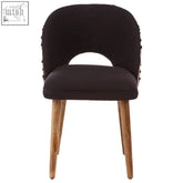 Black velvet cefena moroccan chair with wooden legs and decorative nailhead trim along the backrest